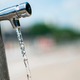 Water runs from a faucet of a water fountain at the Place de Stalingrad on June 25, 2019 in Paris.